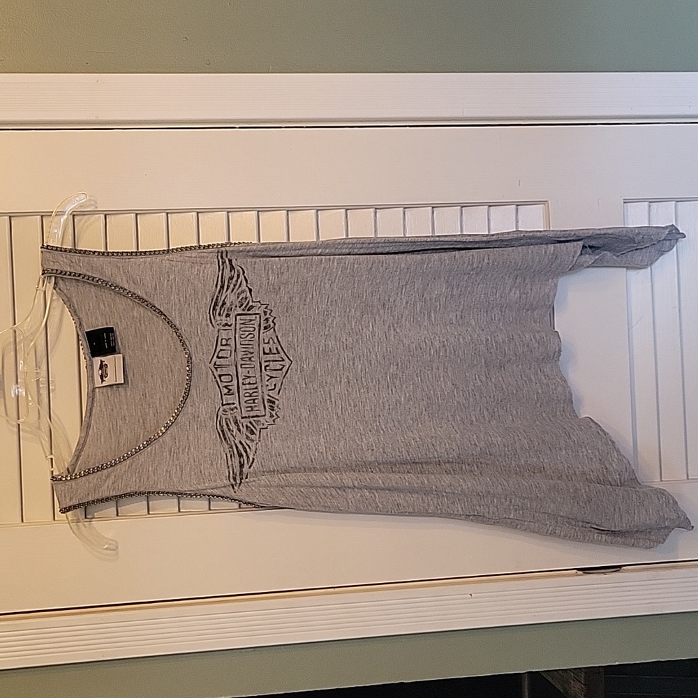 Ladies Harley Davidson tank top with metal trim and sides are long.